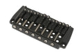 Black metal fixed guitar bridge with seven string saddles and mounting holes on a white background.
