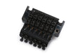 Black 6-string guitar tremolo bridge with adjustable string saddles and locking screws on white background.