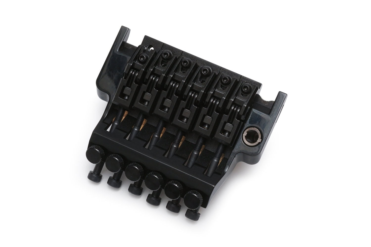 Black 6-string guitar tremolo bridge with adjustable string saddles and locking screws on white background.