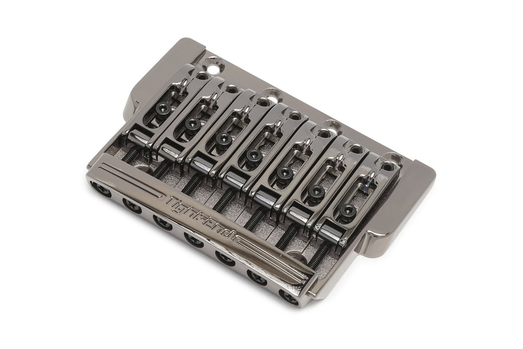 Metal fixed guitar bridge with seven string saddles and adjustment screws labeled Tight-End.
