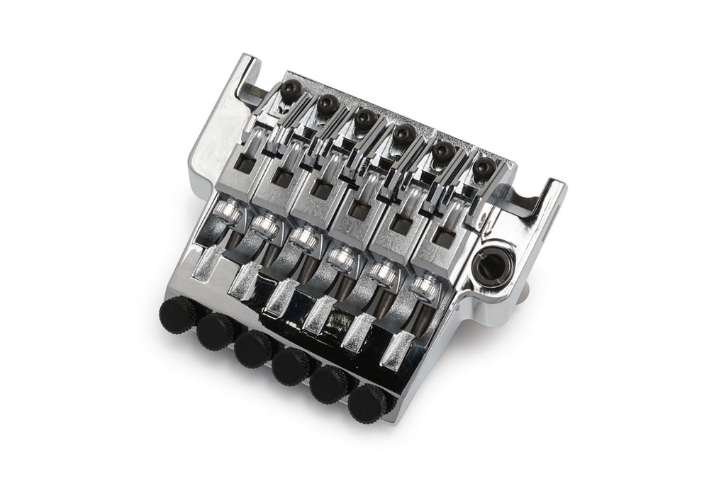 Chrome six-string guitar bridge with adjustable saddles and black screw knobs on white background