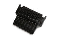 Black guitar tremolo bridge with seven adjustable saddles and screws for string intonation and height.