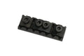 Black metal guitar locking nut with four hex screws and retainer springs on a white background.