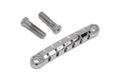 Chrome metal guitar tailpiece with six string slots and two mounting screws on white background.