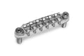 Chrome metal guitar bridge with six adjustable saddles and mounting posts.