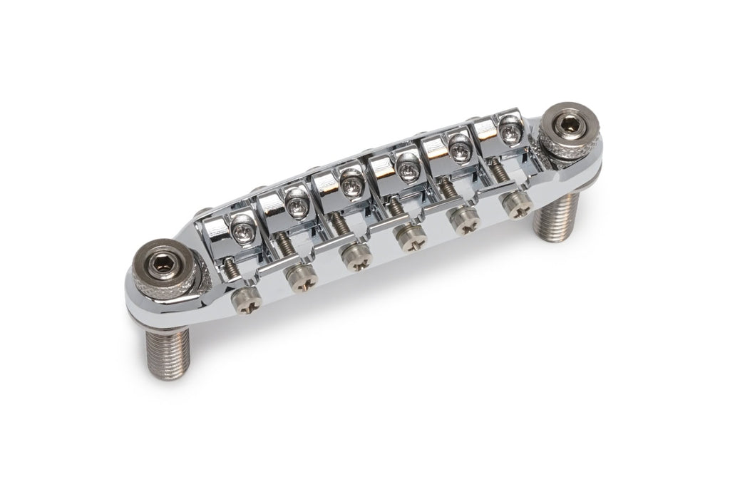 Chrome metal guitar bridge with six adjustable saddles and two threaded mounting posts.