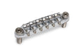Chrome metal guitar bridge with six adjustable saddles and two threaded mounting posts.