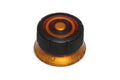 A black and deep honey amber plastic knob with numbered markings on the base ring.