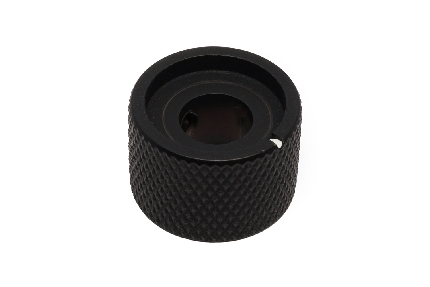 A black textured metal control knob with a small white marker on the side.