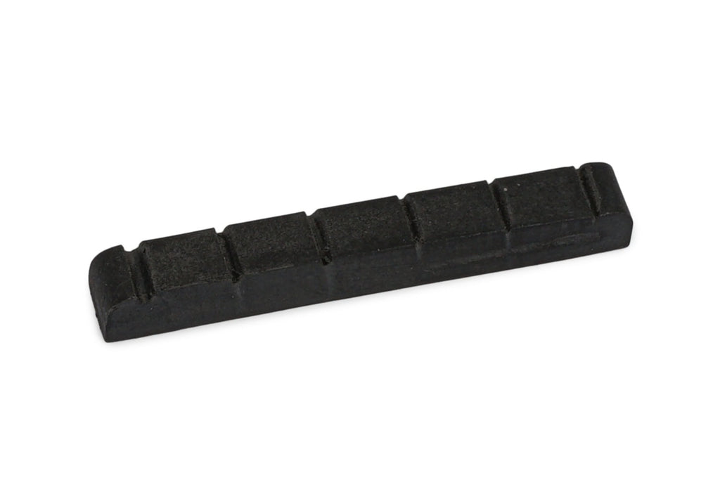 Small black guitar nut with six string slots, shown on white background.