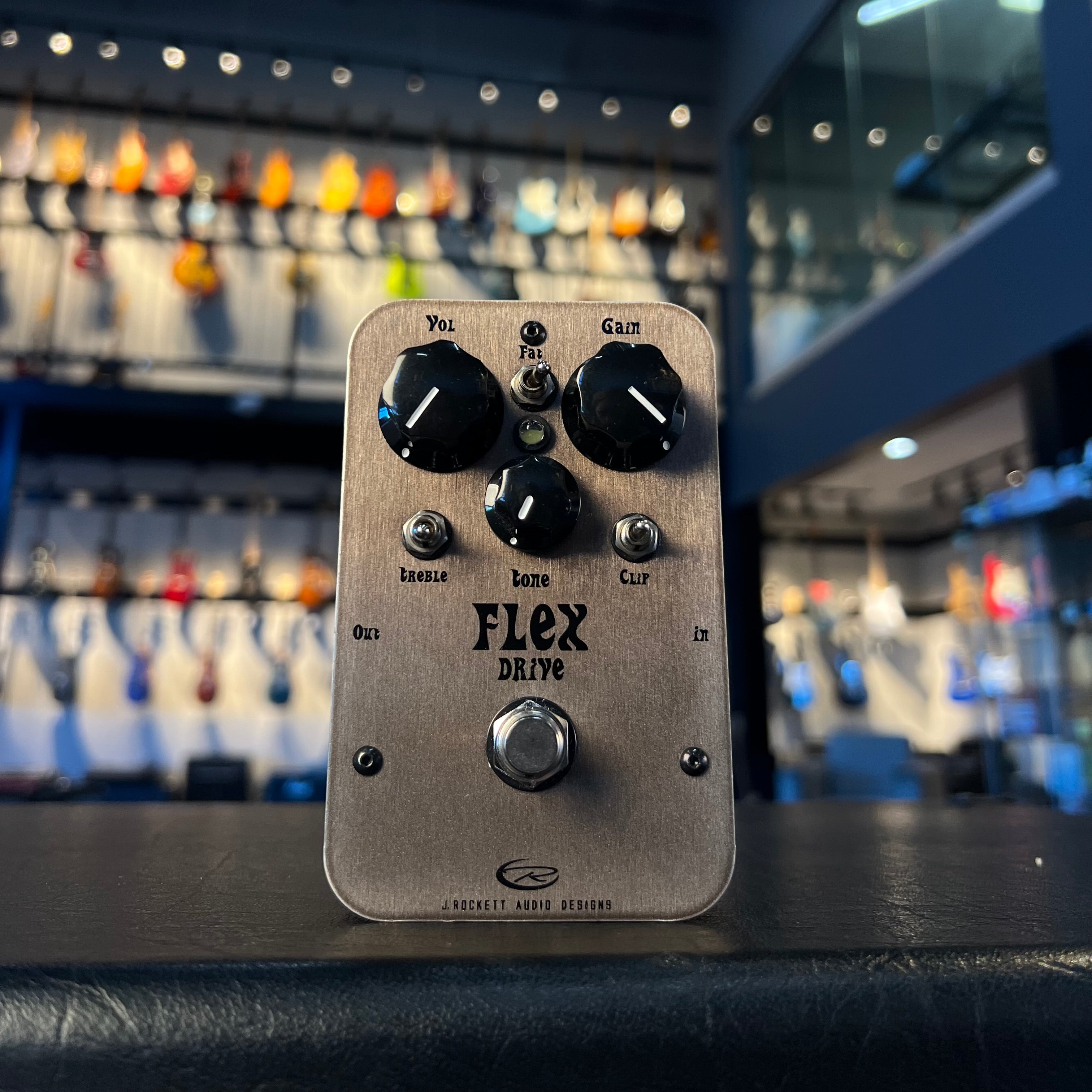 Silver overdrive guitar pedal with black knobs labeled Flex Drive by J. Rockett Audio Designs.