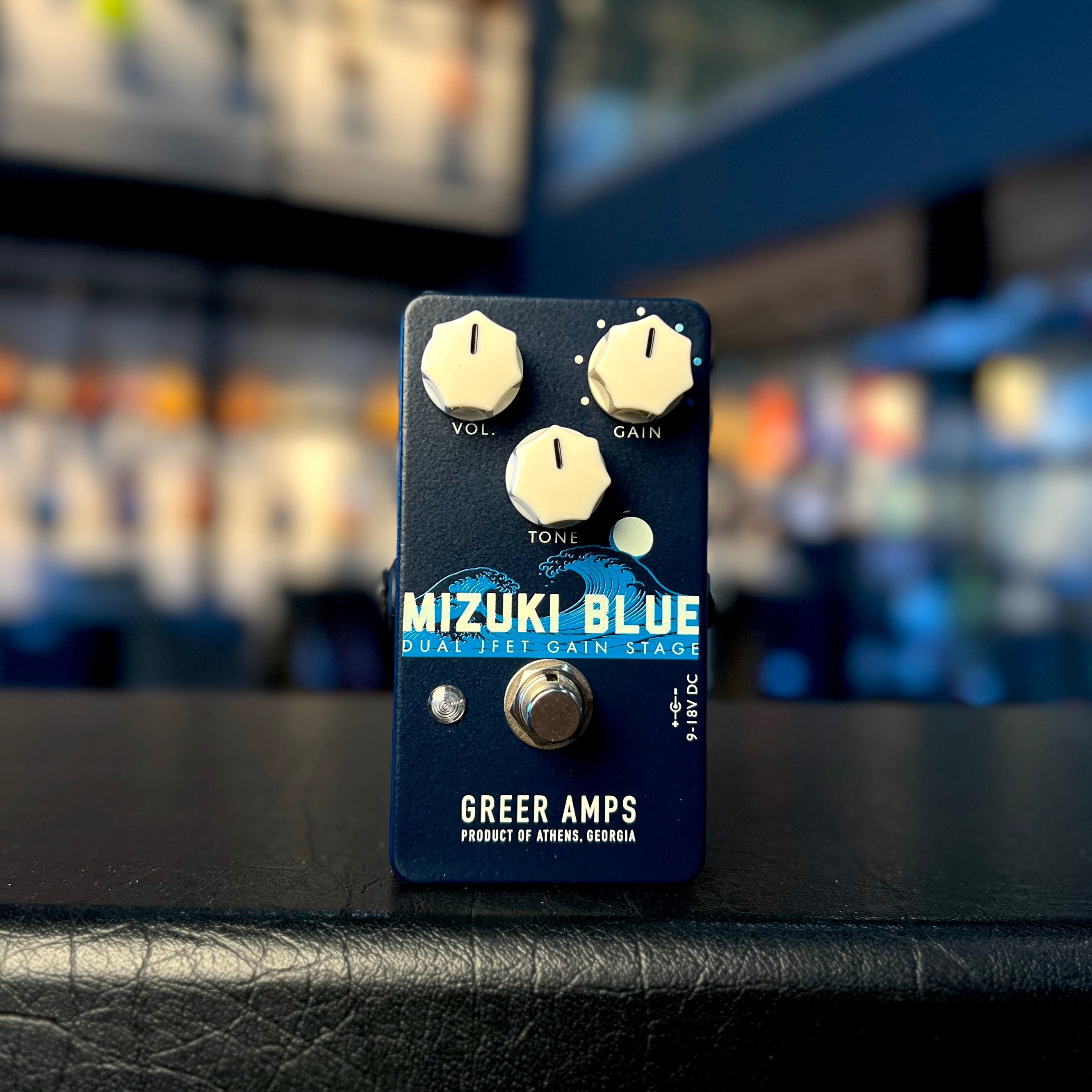 Blue guitar effects pedal with three knobs, one footswitch, and text reading Mizuki Blue by Greer Amps.