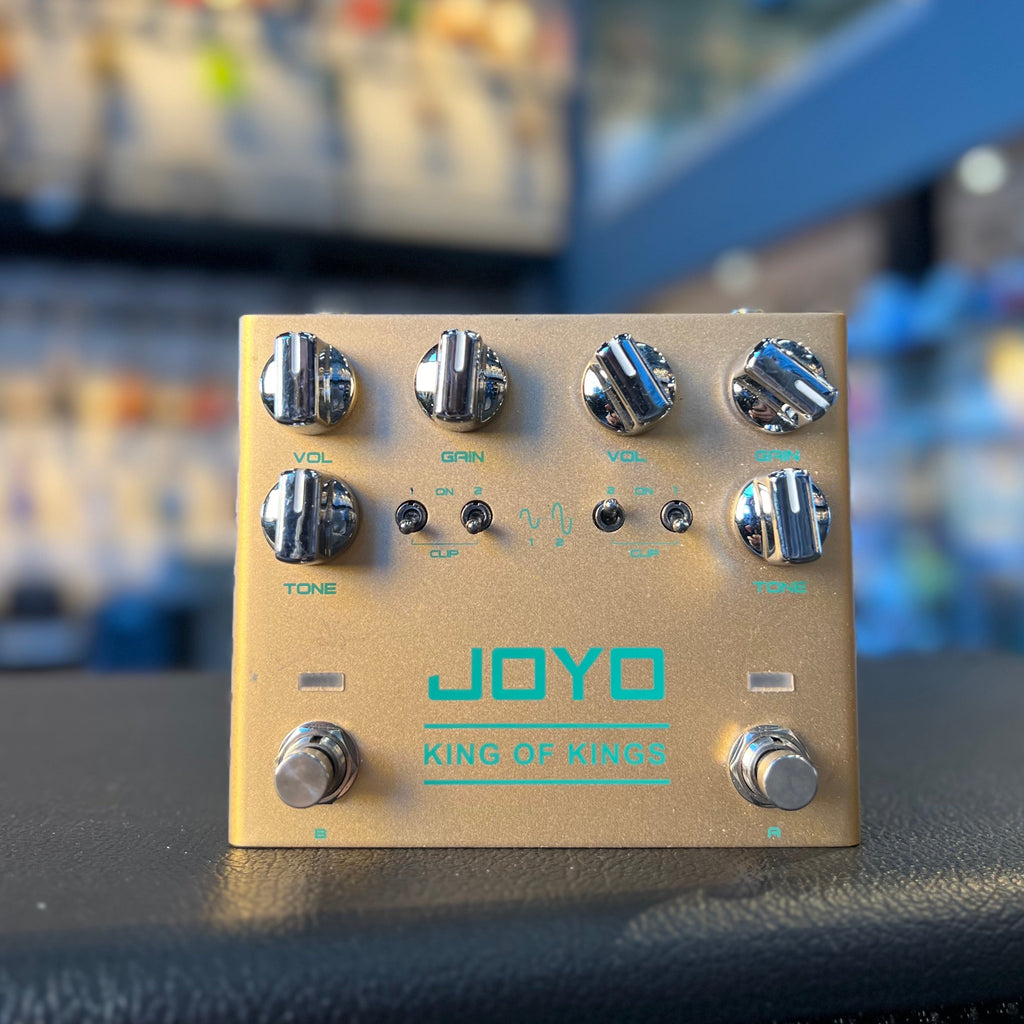 Gold JOYO King Of Kings pedal with two sets of volume, gain, and tone knobs, toggle switches, and footswitches.