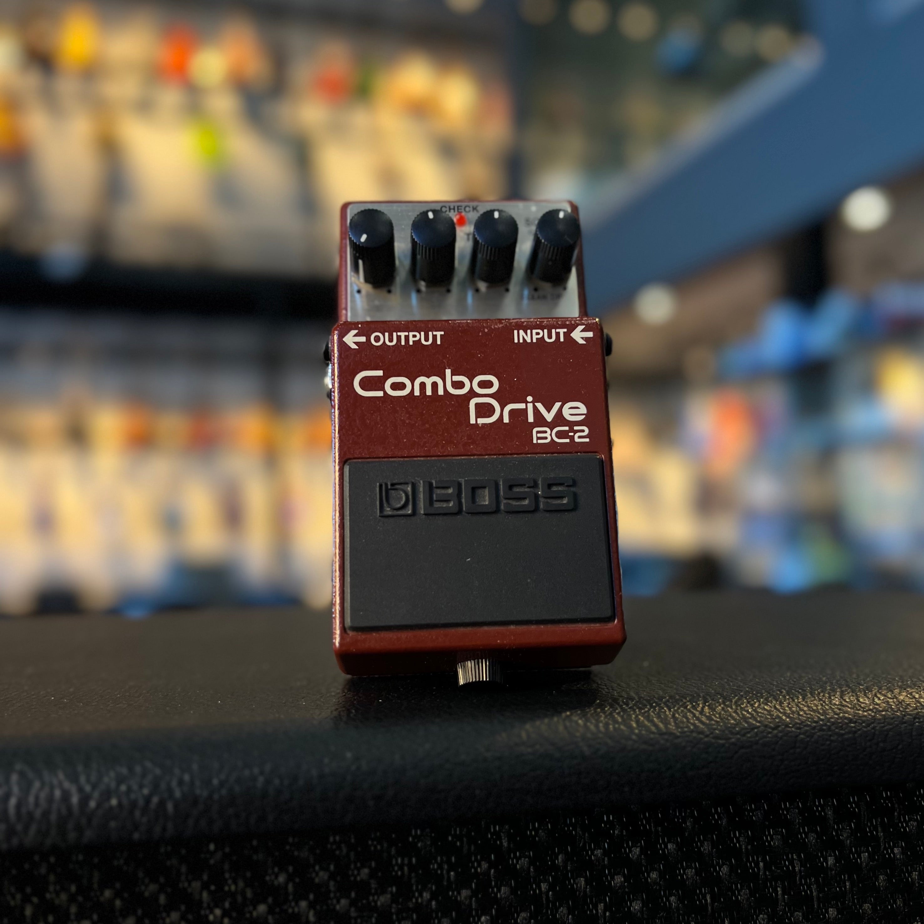 Red BOSS Combo Drive BC-2 overdrive guitar pedal with four black knobs and input/output labeled jacks.
