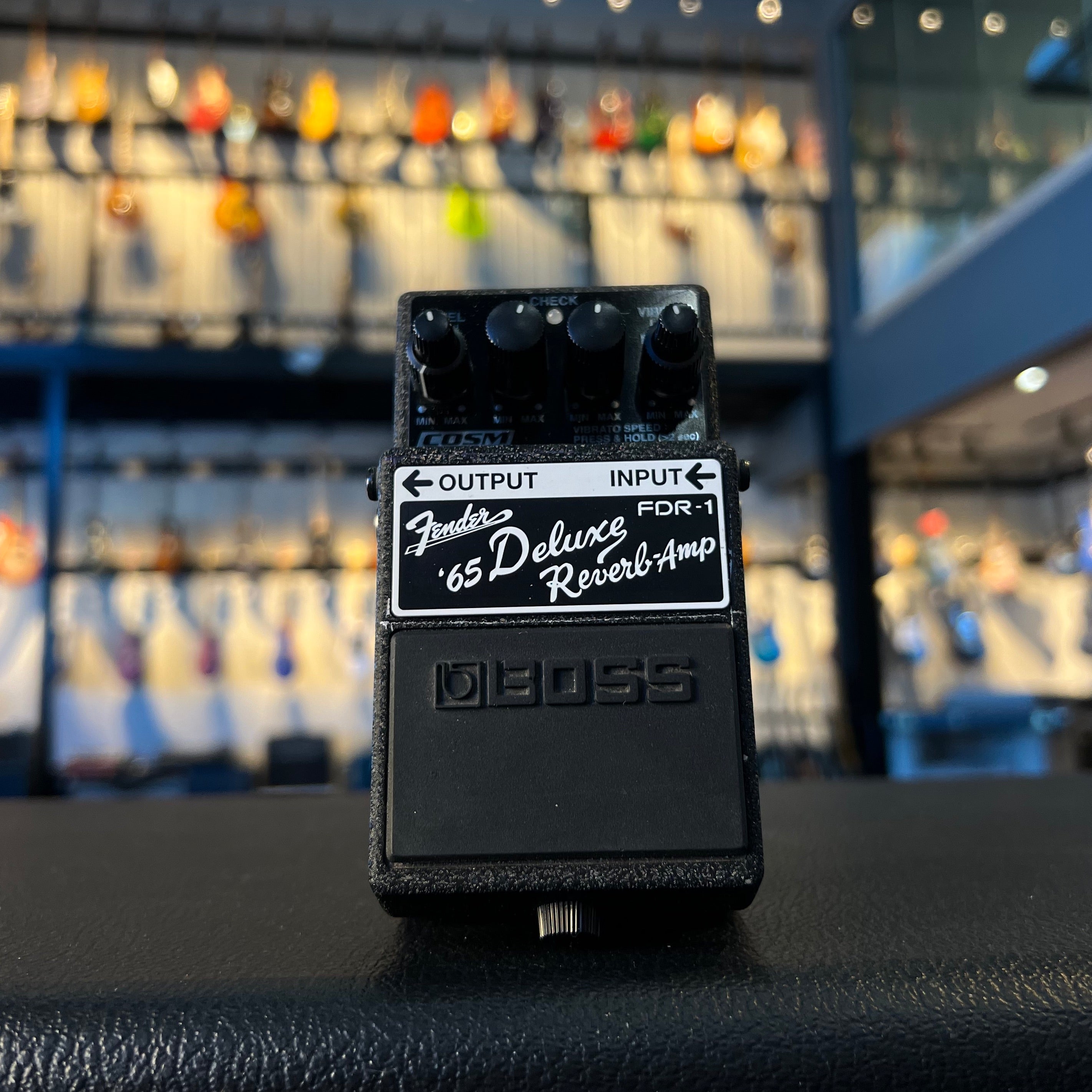 Black BOSS guitar effects pedal with knobs and input/output jacks labeled Fender '65 Deluxe Reverb-Amp FDR-1.