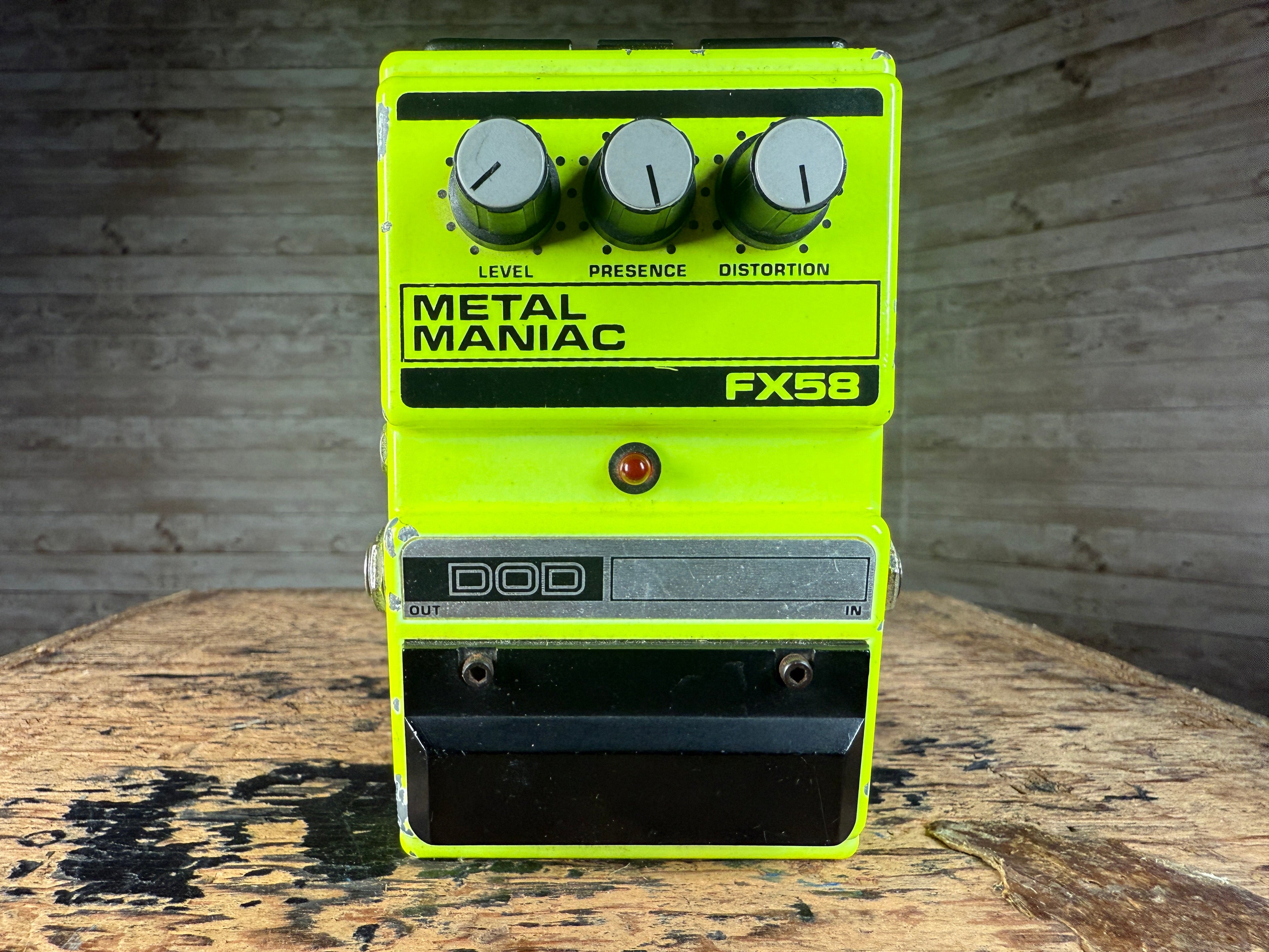 Front view of a yellow guitar effects pedal with three control knobs and input/output jacks.