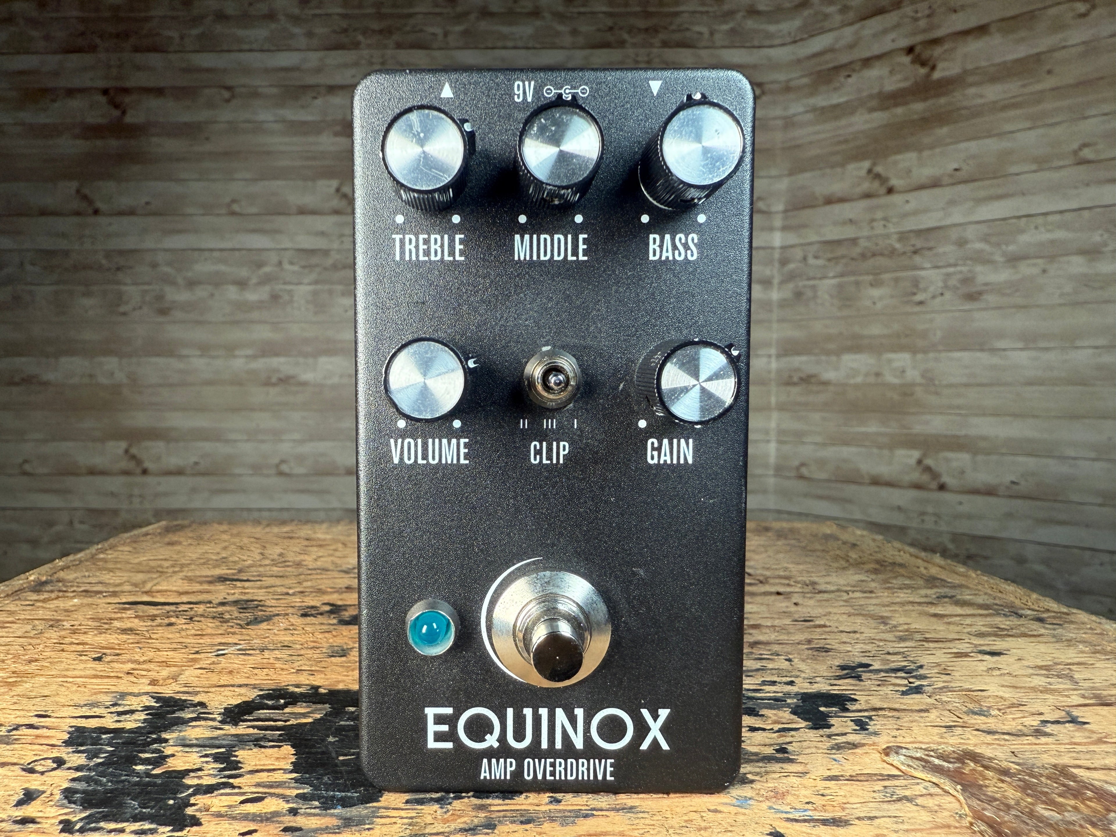 Black Equinox Amp Overdrive pedal with six knobs, a toggle switch, a footswitch, and a blue indicator light.