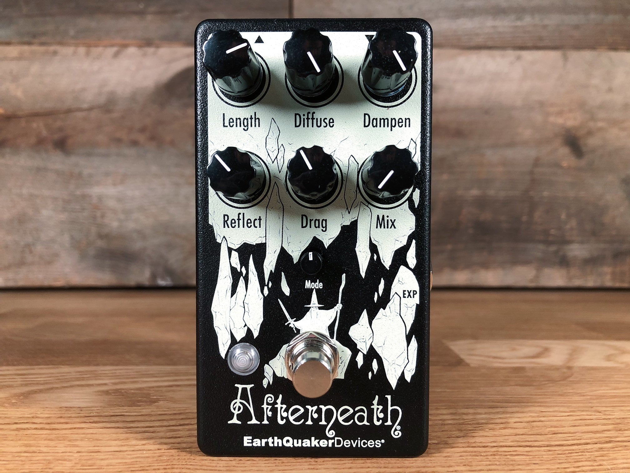 Black EarthQuaker Devices Afterneath guitar effects pedal with six knobs and one footswitch on wooden surface.