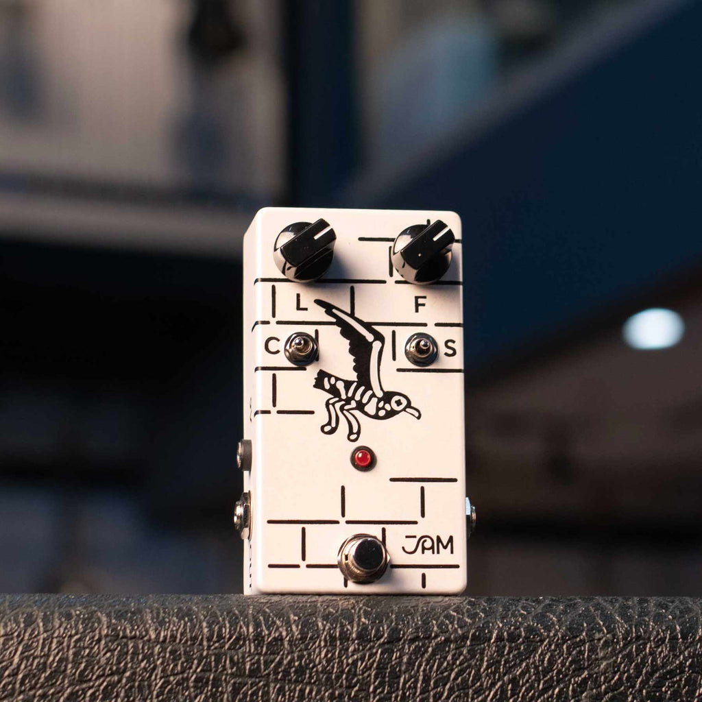 White guitar effects pedal with seagull illustration, two knobs, two toggle switches, and a footswitch.