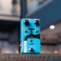 Blue guitar effects pedal with black faucet graphic, three control knobs, two toggle switches, and a footswitch.