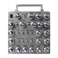 Front view of a metal panel with multiple labeled knobs and switches for audio control.