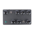 Rectangular black electronic device with eight black rotary knobs, two toggle switches, and one green push button.