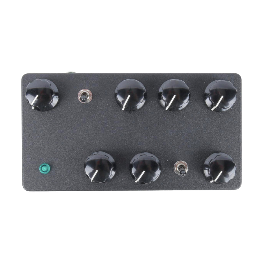 Rectangular black electronic device with eight black rotary knobs, two toggle switches, and one green push button.