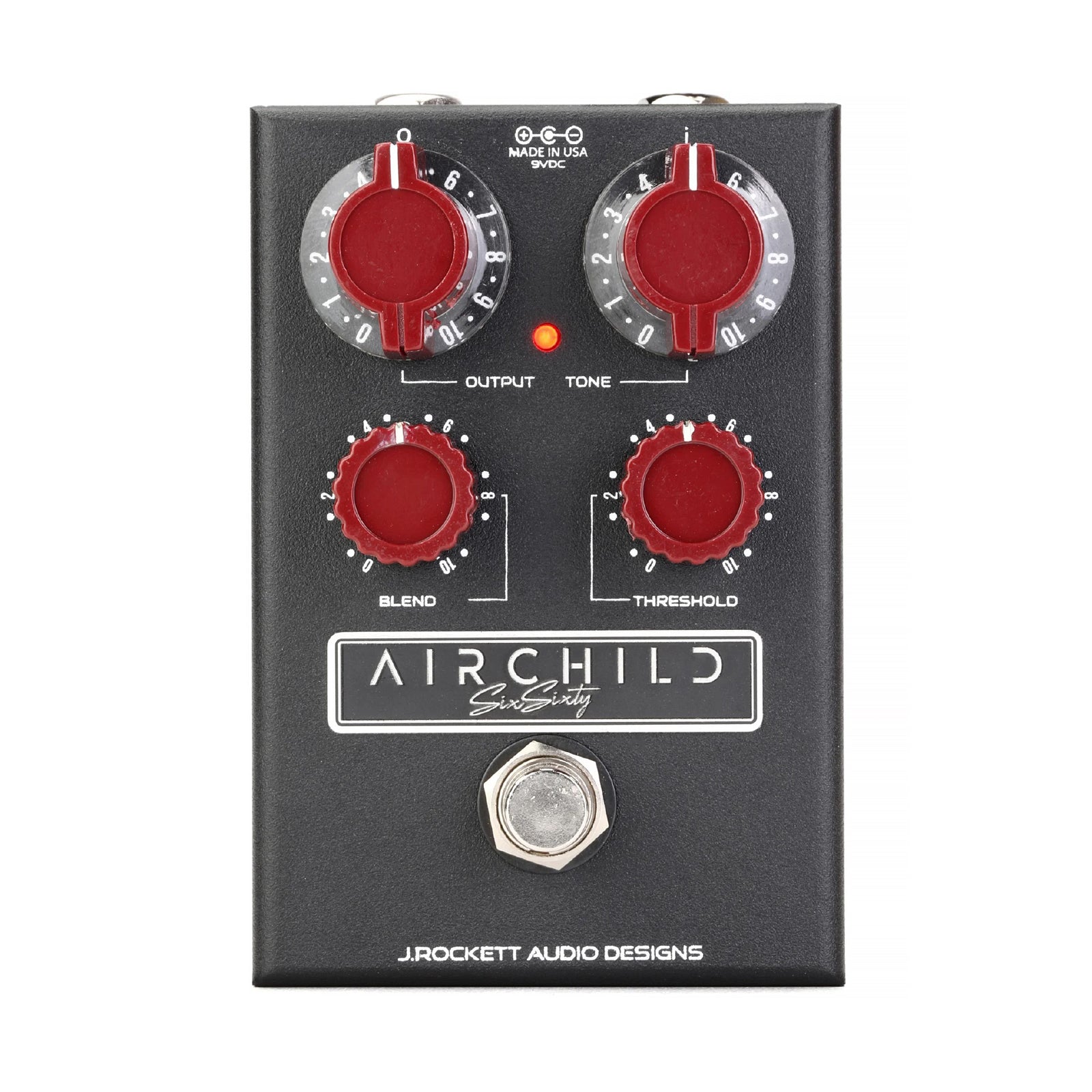 Black guitar effects pedal with four red knobs, one footswitch, and two input/output jacks.