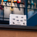 White guitar effect pedal with six control knobs and two footswitches labeled KERNOM RIDGE placed on a textured surface.