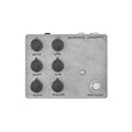 Gray metal guitar effects pedal with six control knobs, one footswitch, and two 1/4 inch audio jacks.