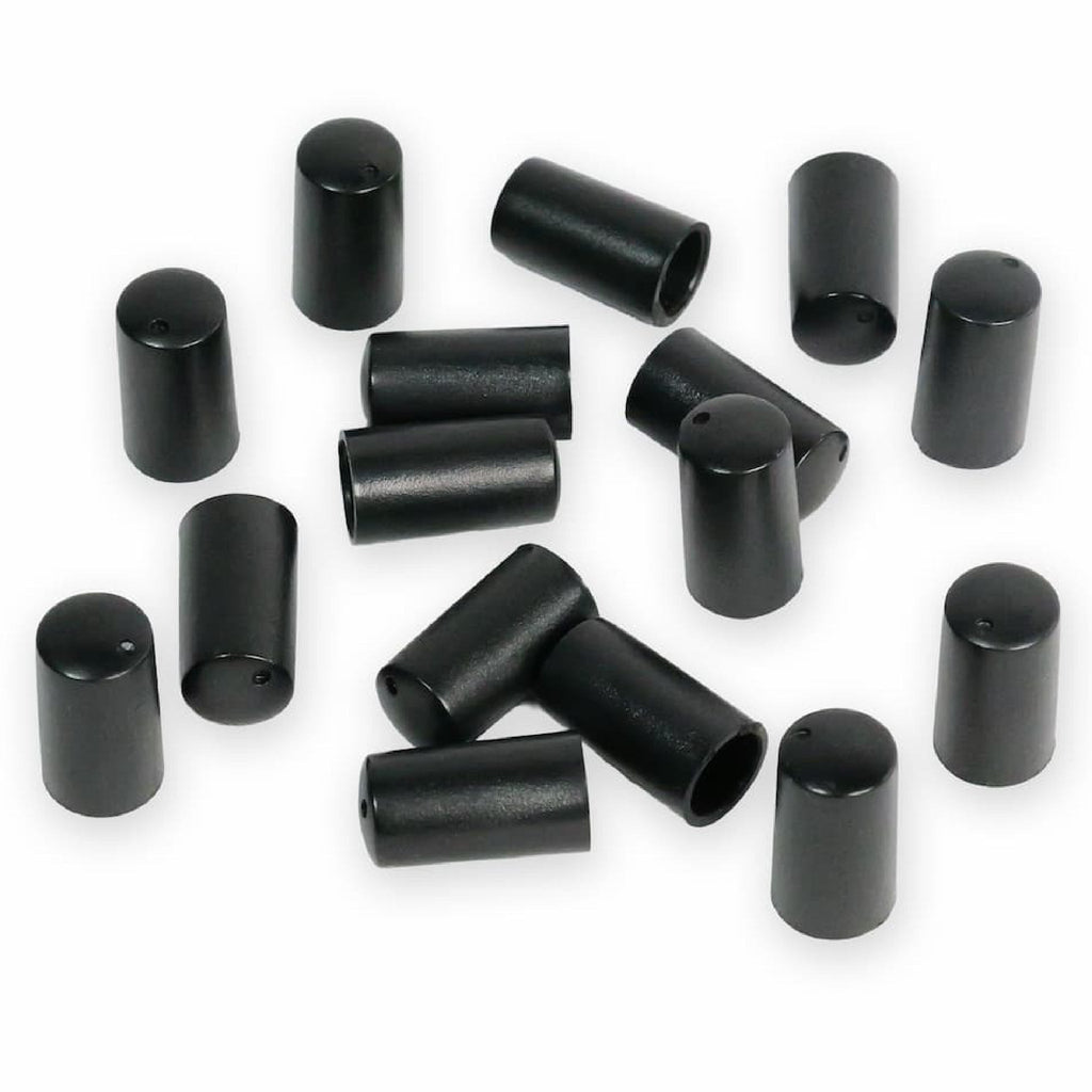 Sixteen black cylindrical knob caps scattered on a white background.