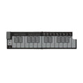 Folded white and gray electronic keyboard controller with multiple sliders, buttons, and keys.