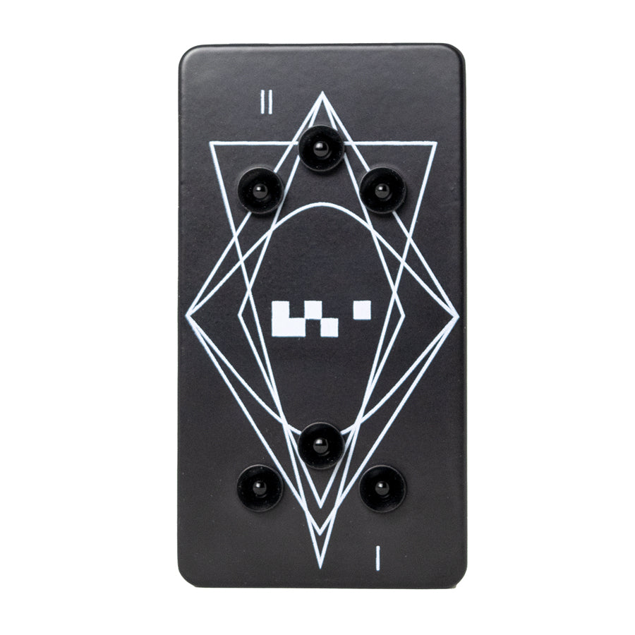 Black rectangular device with five black knobs and white geometric line and square graphics on top surface.