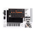 Disassembled electronic keyboard synthesizer kit with control panel, keyboard, cables, components, and manual arranged on white background.