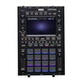 Front view of a black Korg KAOSS Replay sampler with pads, knobs, buttons, and a screen.