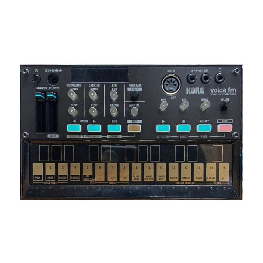 Top view of a black Korg Volca FM digital FM synthesizer with control knobs, buttons, and small keyboard.