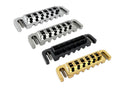 Four guitar bridges in metallic silver, black, and gold finishes with adjustment screws.