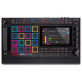 Top view of a black music production controller with colored pads, rotary knobs, buttons, and a touchscreen display.