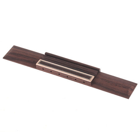 A rosewood classical style guitar bridge with multiple string holes and a cream-bordered saddle.