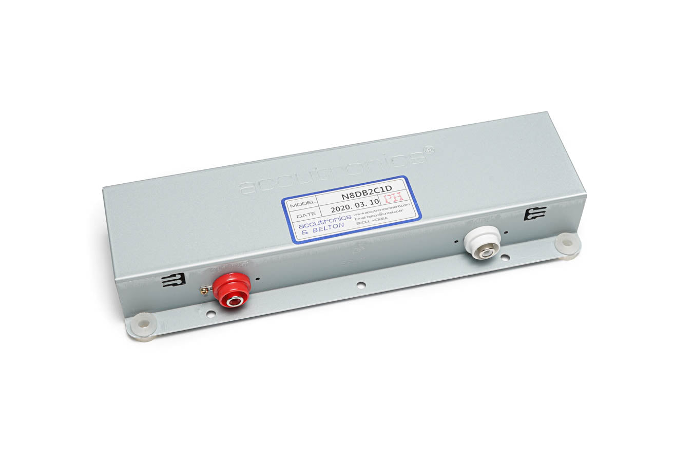 Gray metal reverb tank with red and white binding post connectors and a label showing model and date information.