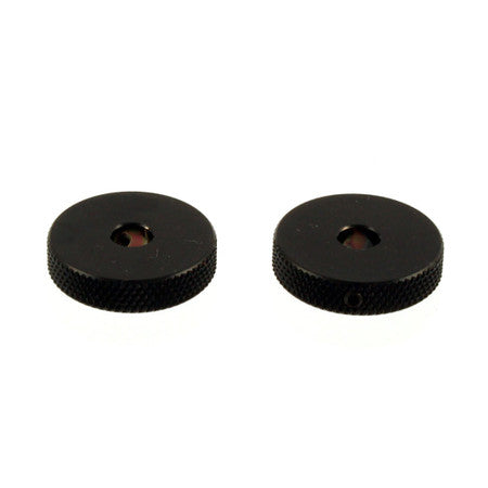 Two black circular metal rotary knobs with textured edges shown on white background.