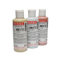 Three bottles of Mixol Glitter Effect-tinting paste in gold, silver, and multi colors with flip-top caps.