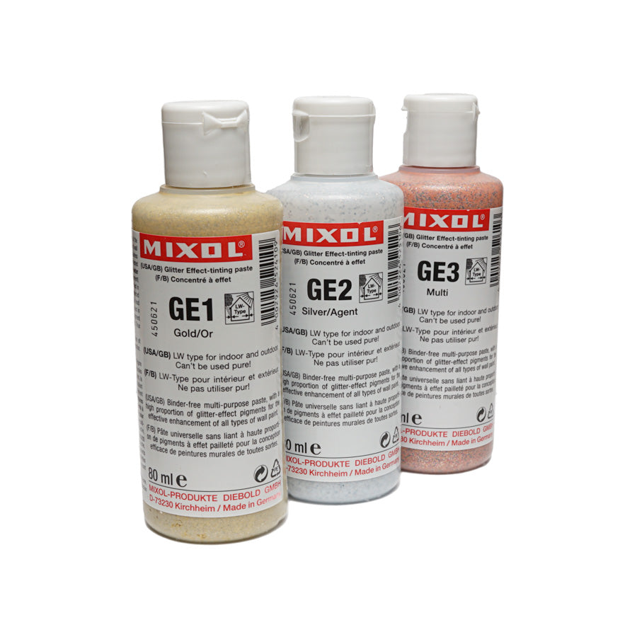 Three bottles of Mixol Glitter Effect-tinting paste in gold, silver, and multi colors with flip-top caps.