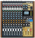 Top view of a Tascam Model 12 audio mixer with knobs, faders, buttons, headphone jacks, and an LCD screen.