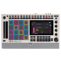 Top view of white music production center with colorful pads, knobs, touchscreen display, and various control buttons.