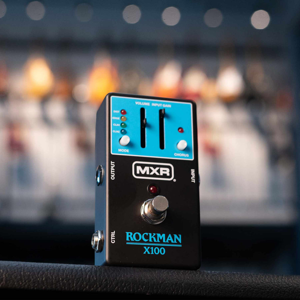 Black MXR Rockman X100 guitar effects pedal with blue control panel, sliders, footswitch, and multiple control knobs and LEDs.