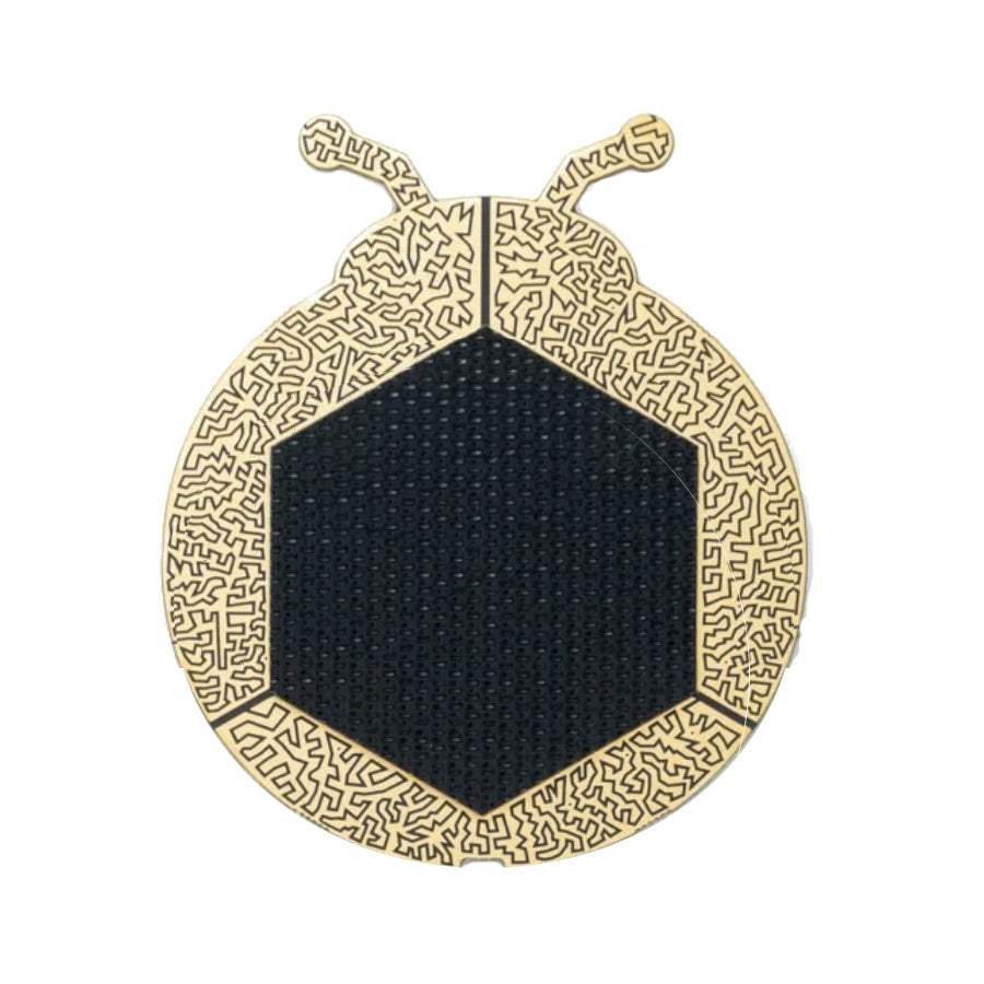 Hexagonal black fabric area surrounded by beige wooden frame shaped like a stylized insect.