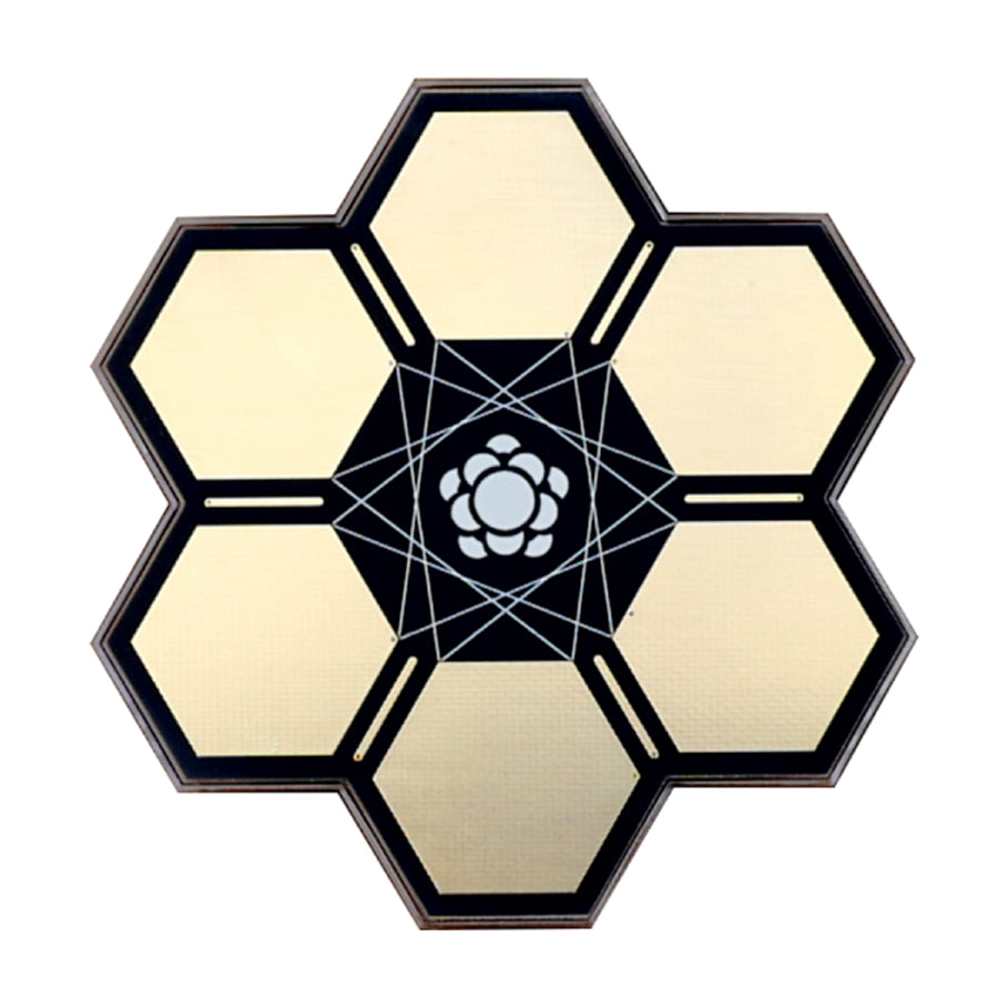 Hexagonal device with six segments and a central flower-like pattern and metal contact points on some edges.