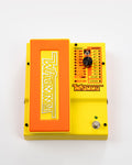 Yellow and orange guitar effects pedal with labeled switch, knob, footswitch, and input jacks.