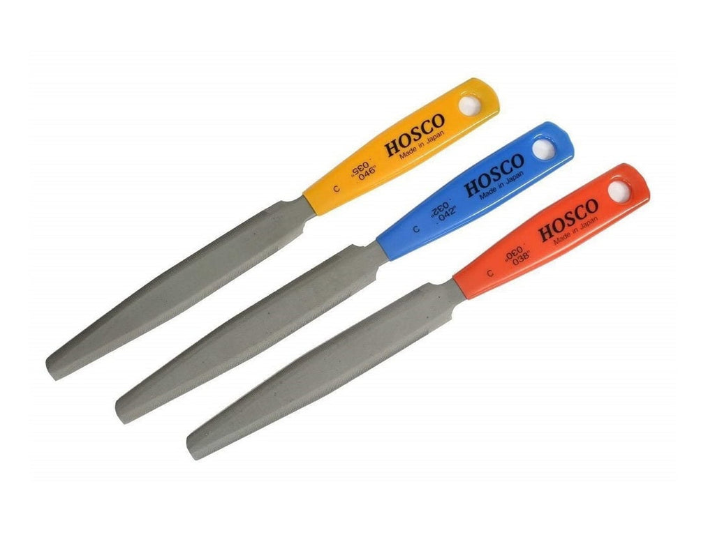 Three double-edged metal files with colored handles labeled HOSCO made in Japan.